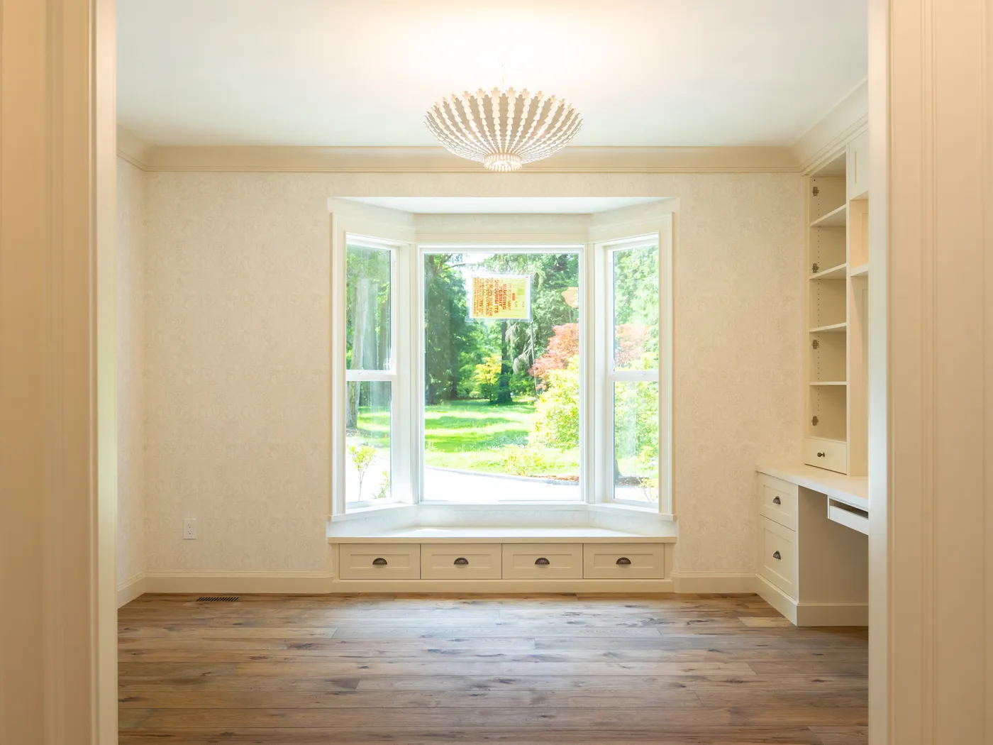 Bay window reading nook with built-in bench and shelving