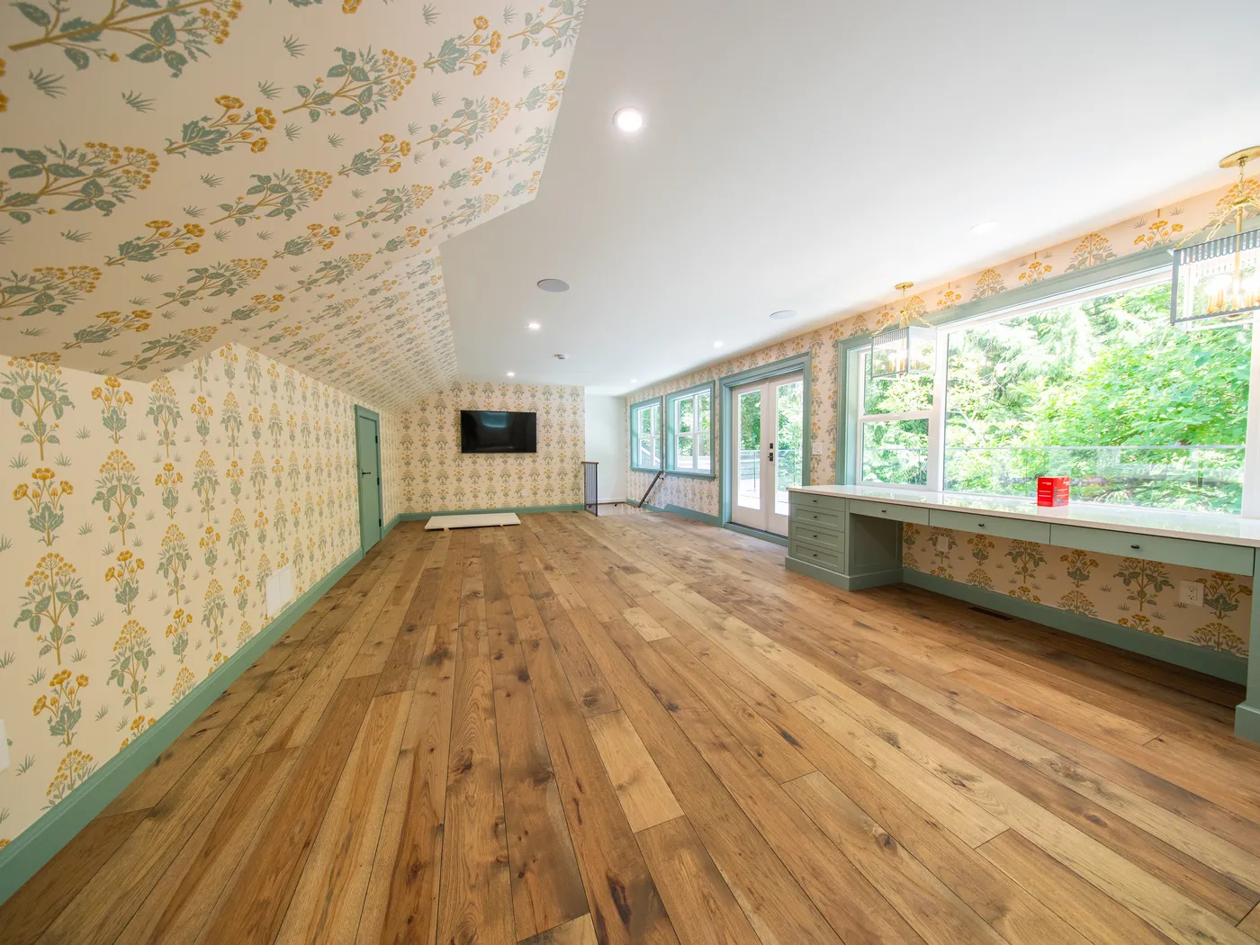 Sunroom addition with floral wallpaper and wall of windows