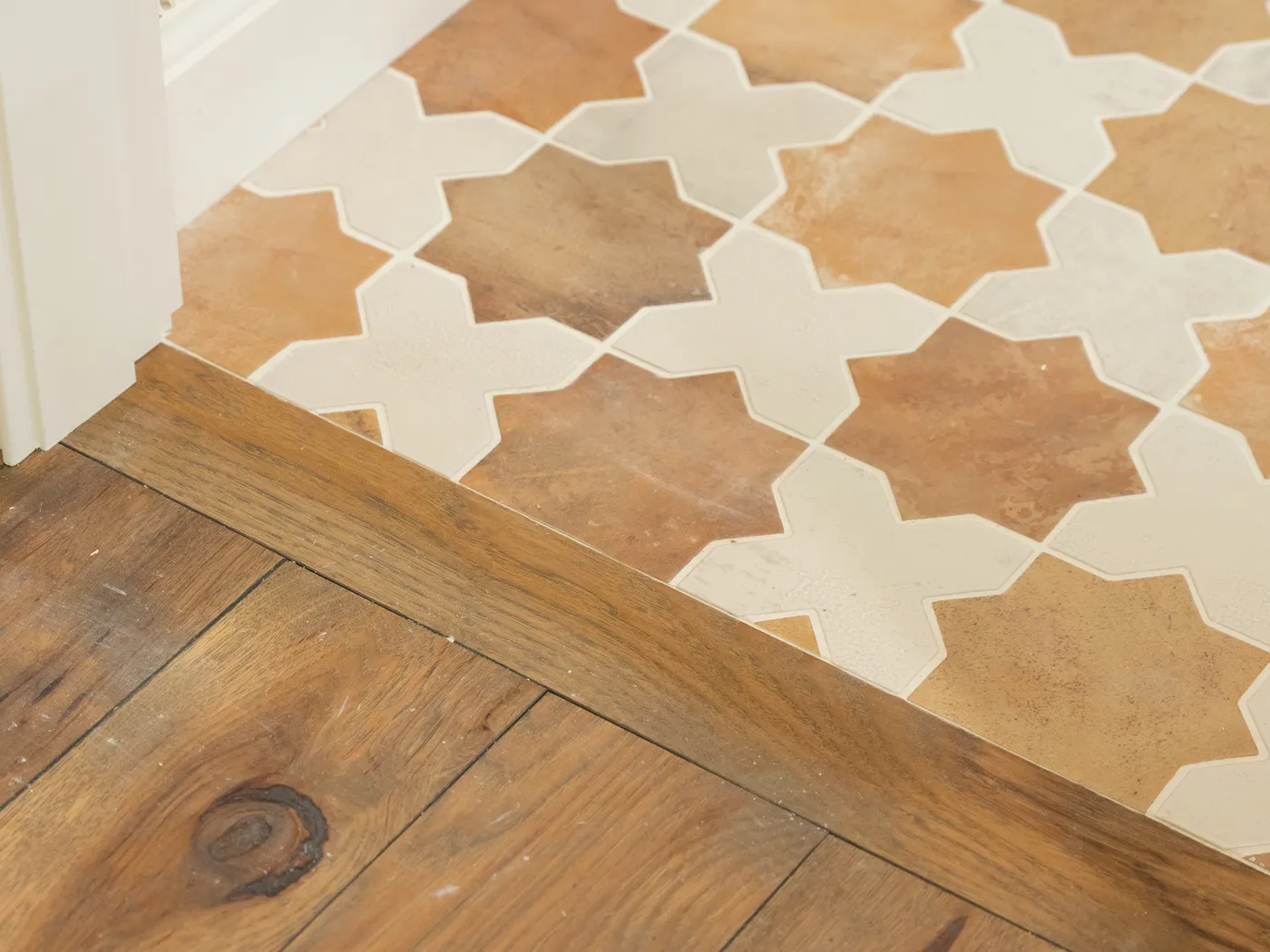 Patterned encaustic tile meeting oak flooring