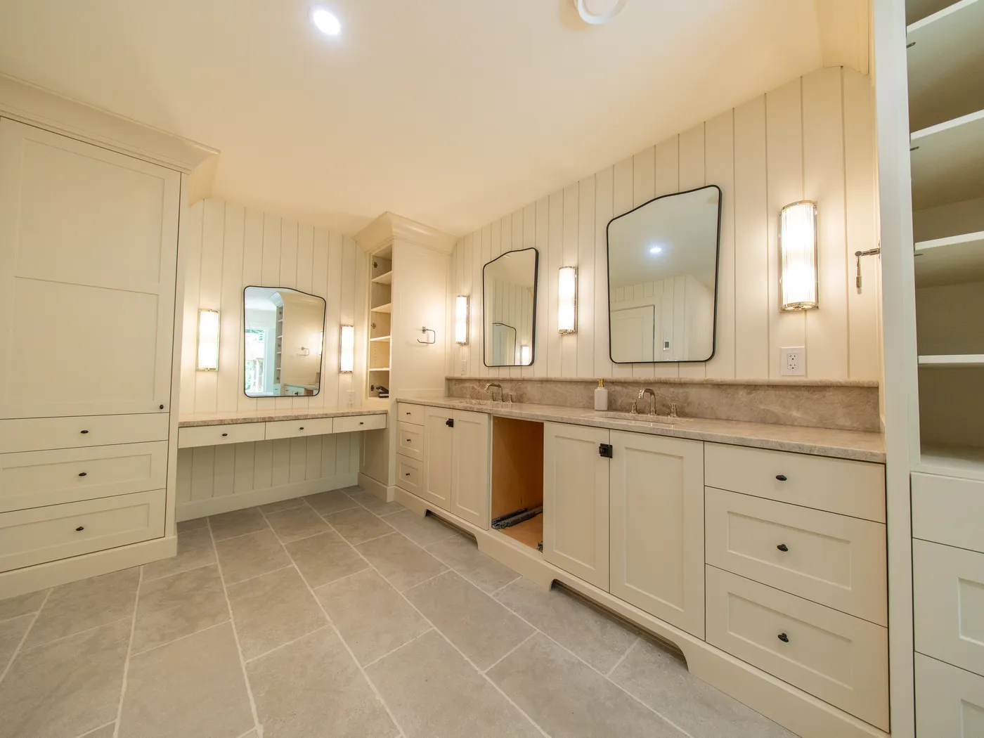 Double vanity with stone counters and built-in linen storage